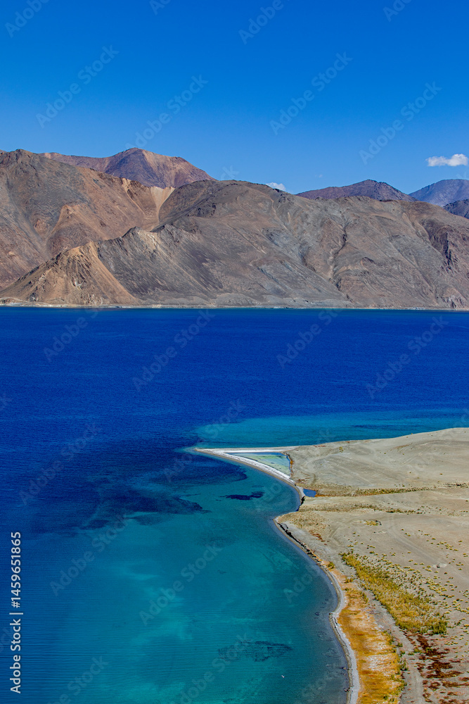 Fototapeta premium Landscape with mountains on the lake named Pagong Tso or Pagong Lake, situated on the border with India and China, Leh, Ladakh, India. one of the world's highest brackish water lake