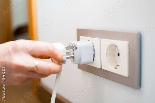 Tableau sur toile Universal travel adapter in a socket close-up