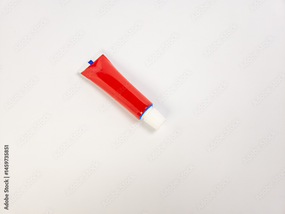 Red tube of cream on white background, healthcare and medicine concept Red tube of cream on white background, healthcare and medicine concept