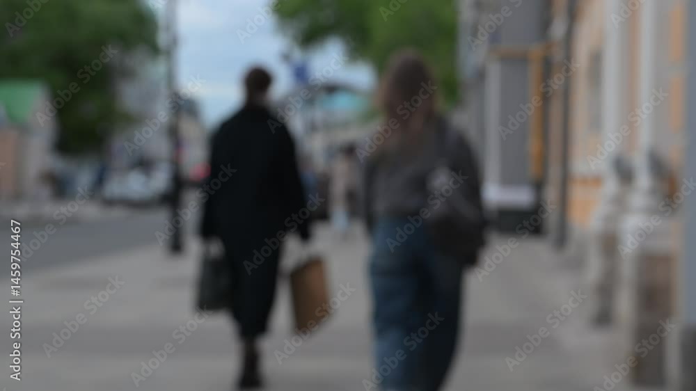 Strolling people in the daytime in a megalopolis on a blurred background. The mysterious way of urban life Strolling people in the daytime in a megalopolis on a blurred background. The mysterious way of urban life