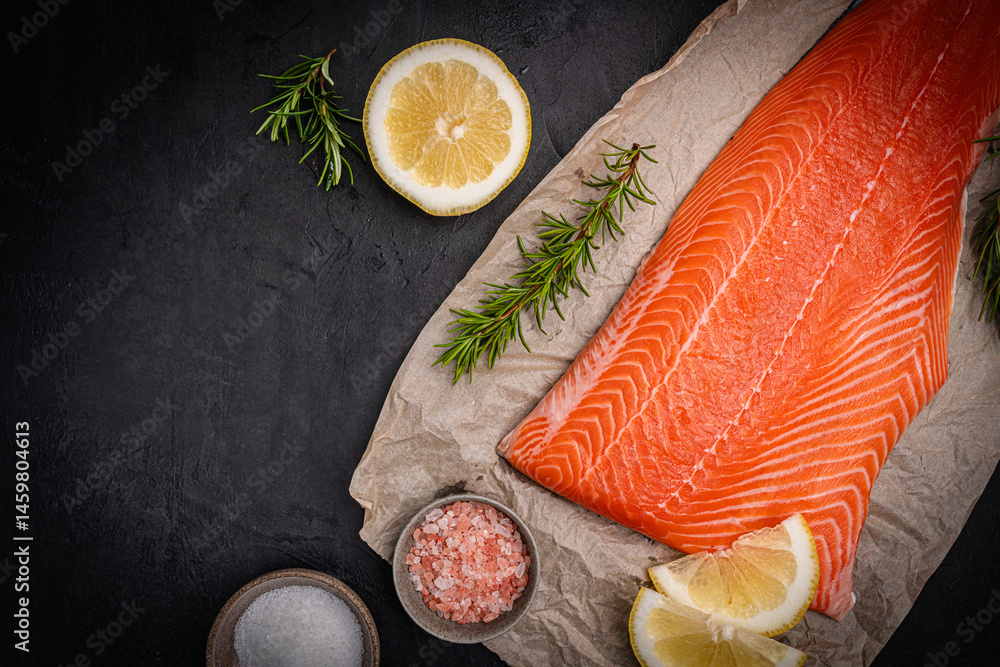 Salmon. Fresh raw salmon fish fillet with cooking ingredients on dark background, top view. High quality photo