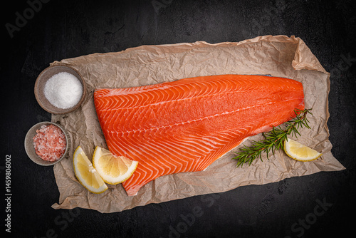 Obraz na płótnie Salmon. Fresh raw salmon fish fillet with cooking ingredients on dark background, top view. High quality photo w salonie