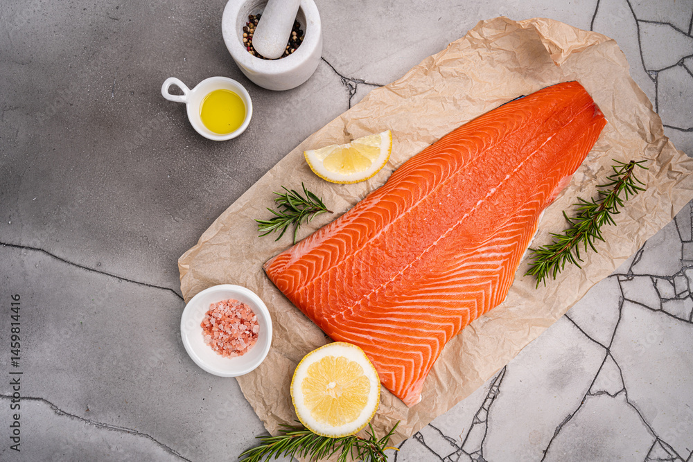 Salmon. Fresh raw salmon fish fillet with cooking ingredients on gray background, top view. High quality photo