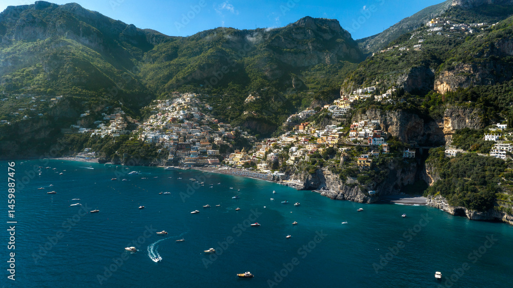 Panoramic aerial view of Positano in the province of Salerno, Campania, Italy. The town is one of the most touristic and beautiful destinations on the Amalfi Coast. The city overlooks the blue sea.