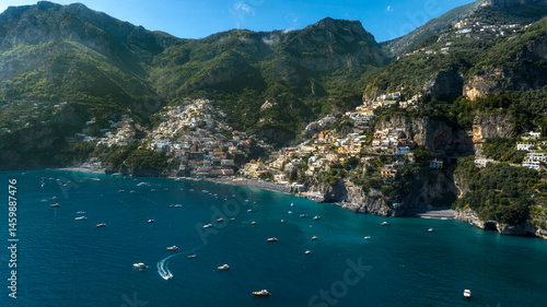 Panoramic aerial view of Positano in the province of Salerno, Campania, Italy. The town is one of the most touristic and beautiful destinations on the Amalfi Coast. The city overlooks the blue sea.