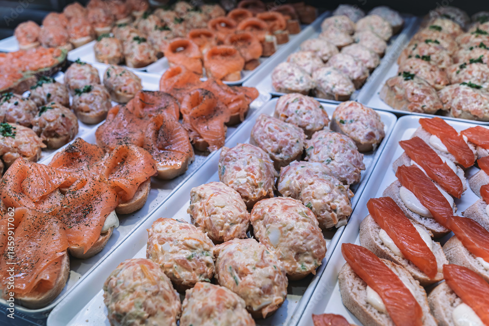 Naklejka premium Assorted salmon tapas on display in Mercado de San Miguel, Madrid.