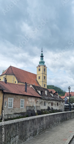 Obraz na płótnie View of the Church of St. Anastasia in Samobor with its distinctive tower and surrounding buildings under an overcast sky w salonie