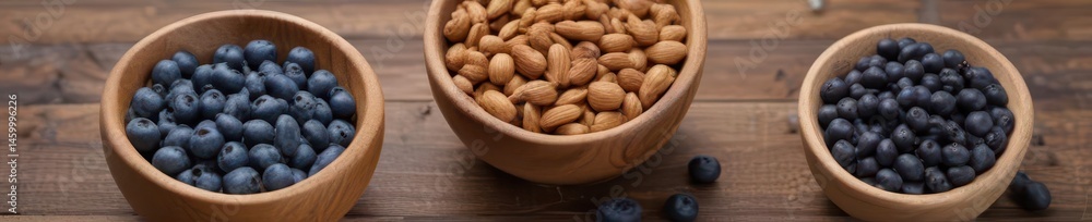 A rustic wooden table holds bowls of nuts and blueberries , autumn, diet A rustic wooden table holds bowls of nuts and blueberries , autumn, diet