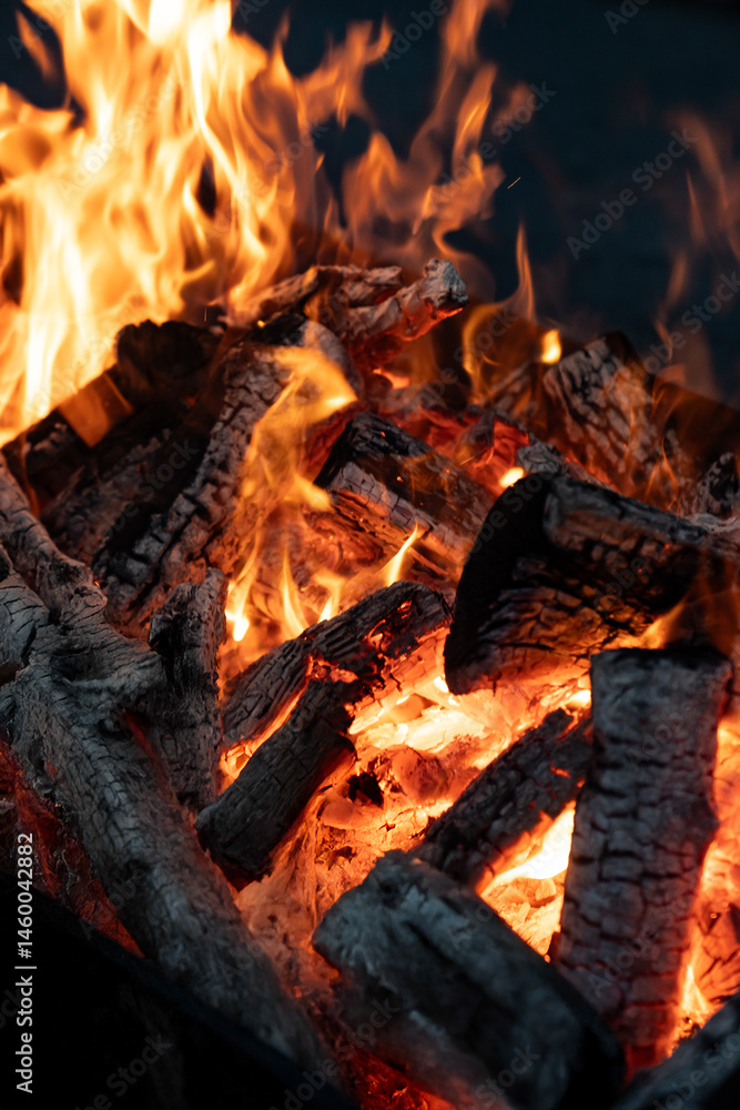 Flame wood in bonfire. Camp barbecue wood charcoal burns in the grill. Blaze fire flame texture background. Tongues of flame. burning wooden logs and large orange flame. Glowing Firewood campfire. Flame wood in bonfire. Camp barbecue wood charcoal burns in the grill. Blaze fire flame texture background. Tongues of flame. burning wooden logs and large orange flame. Glowing Firewood campfire.