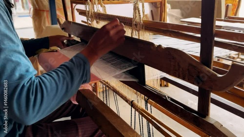 Silk farm. Woman weaving on a traditional loom. Traditional cotton hand weaving.
