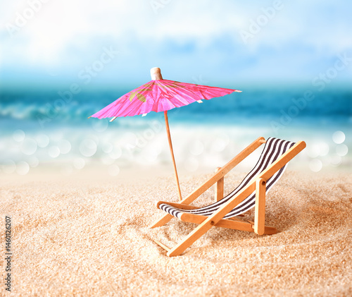 Fototapeta Naklejka Na Ścianę i Meble -  Beach chairs on the gold sand beach with umbrella, cloudy blue sky and sun
