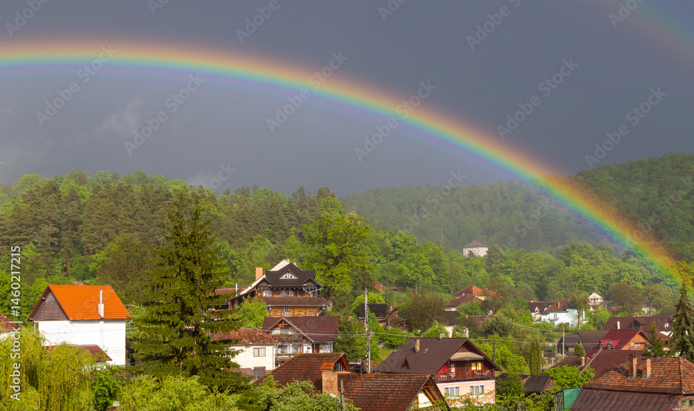 A spectacular landscape with a rainbow over a rural village