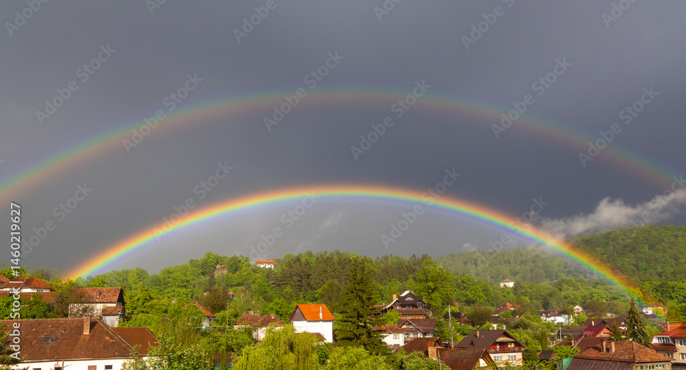 Landscape with a double rainbow above the houses of a village