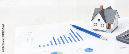 Real estate model with financial graphs and copy space  