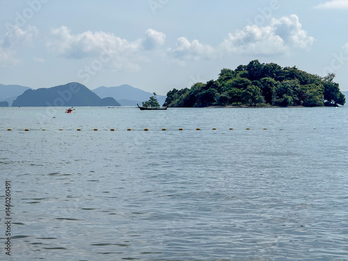 Obraz na płótnie Secluded beach top with tropical scenery and a hidden paradise, showcasing pristine sandy beaches, palm trees and small islands on the stunning ocean waters. Exotic Thai panorama. w salonie