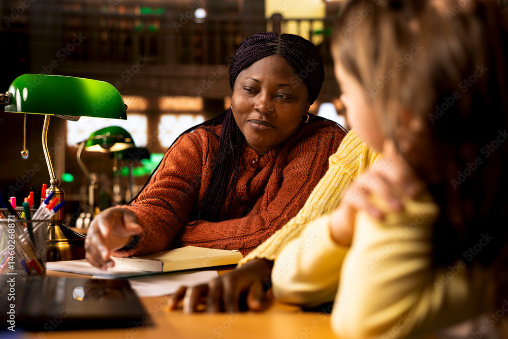 Elementary school professor engaging with girls students during private lessons, provides tutoring and guidance on specific curriculum subjects. Teacher helping the classmates with new ideas.