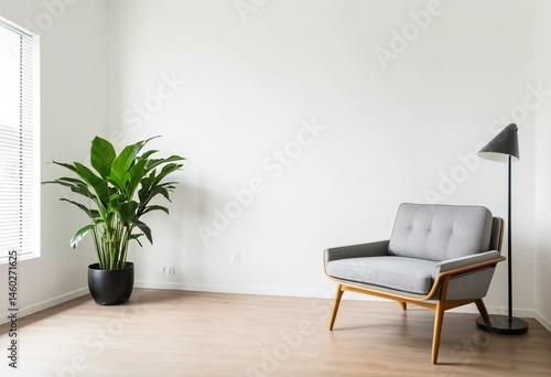 A living room with a green chair and a plant.