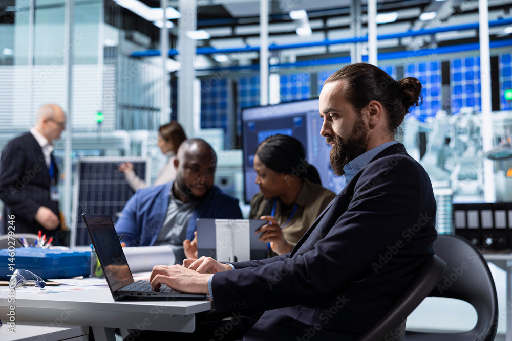 Factory scientists doing research and development, working on manufacturing automation advancements. Industrial plant experts analyze technical data during meeting, doing strategic production planning