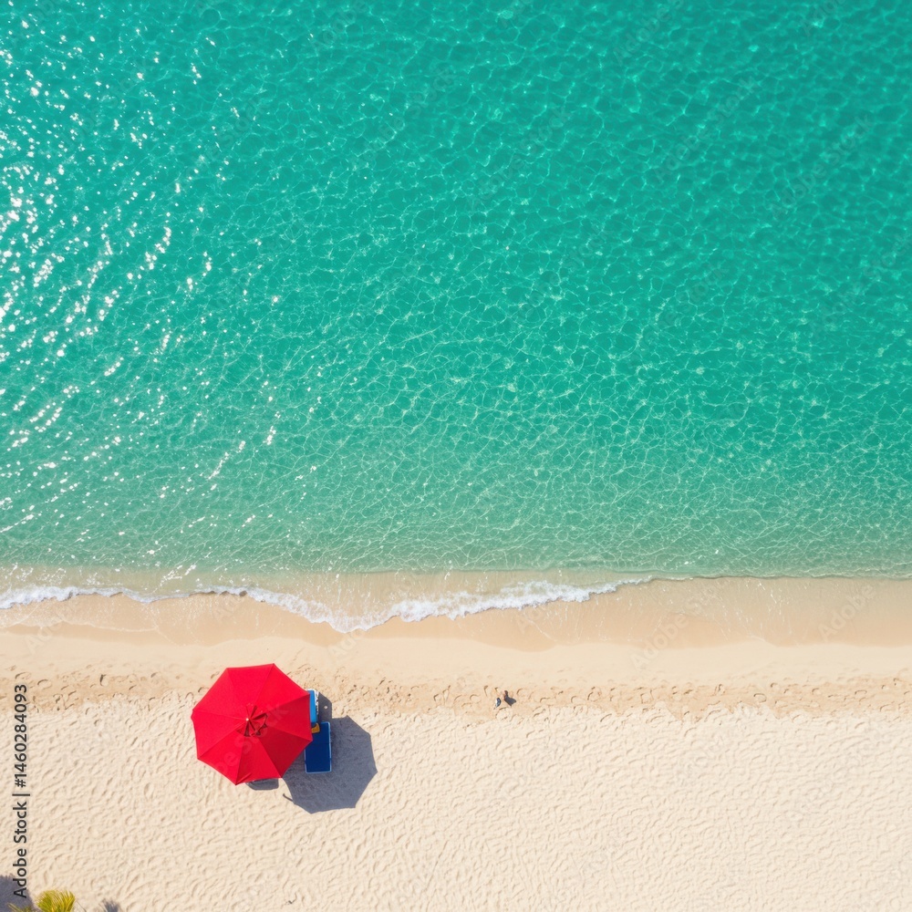 Naklejka premium Aerial view of a tropical beach with turquoise water and a red umbrella on the white sand shore