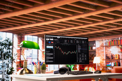 Application on computer screen in apartment used for analyzing crypto coins investment graph fluctuations. Forex volatile assets candlestick chart on PC monitor on home office desk