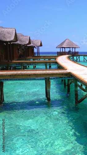 Tropical travel scene with ocean seascape and luxury water bungalows. Vertical footage