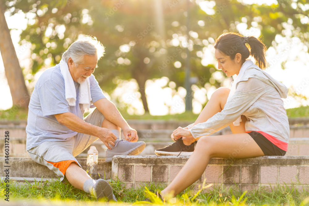 Fototapeta premium Happy Asian family senior man and adult child do sport training workout exercise together at park. Father and daughter tie shoelaces while running in city. Elderly people wellness healthcare concept.