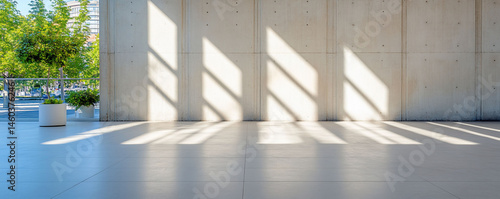 Modern architectural space with sunlight and shadow on concrete wall and tiled floor