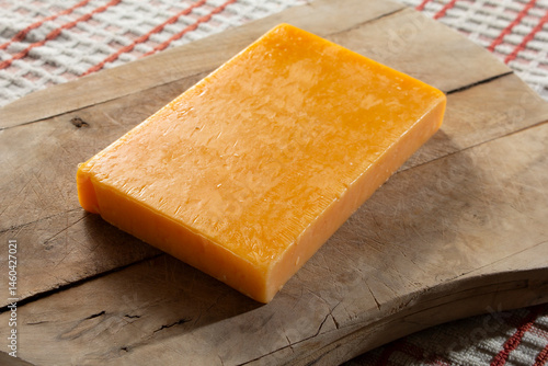 A view of a block of mild California cheddar cheese.