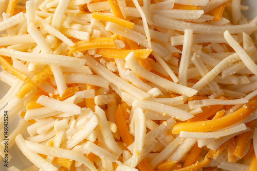 A top down view of a pile of dairy-free shredded cheese, as a background.