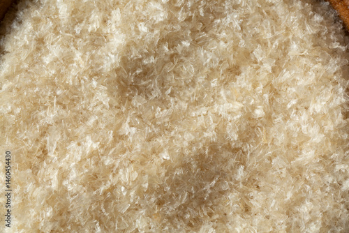 Bild auf Leinwand A top down view of a bowl of agar agar flakes, as a background.