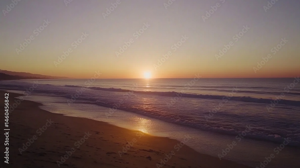 Gentle ocean waves lapping at a sandy shore at sunrise. Gentle ocean waves lapping at a sandy shore at sunrise.