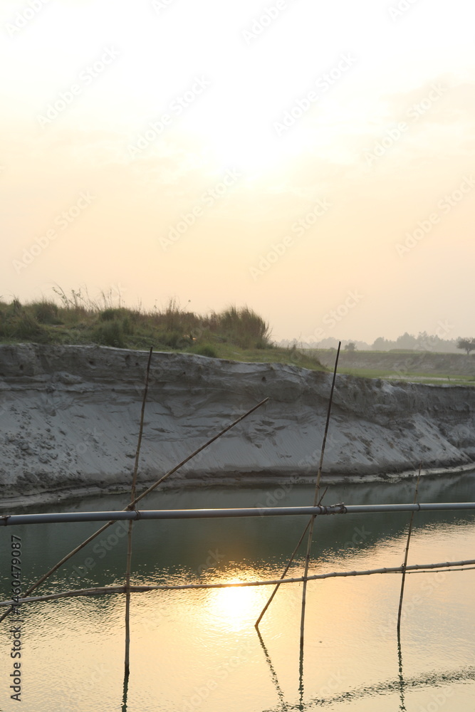 River View with bamboo pole, sand texture, and sky, creating a scenic landscape