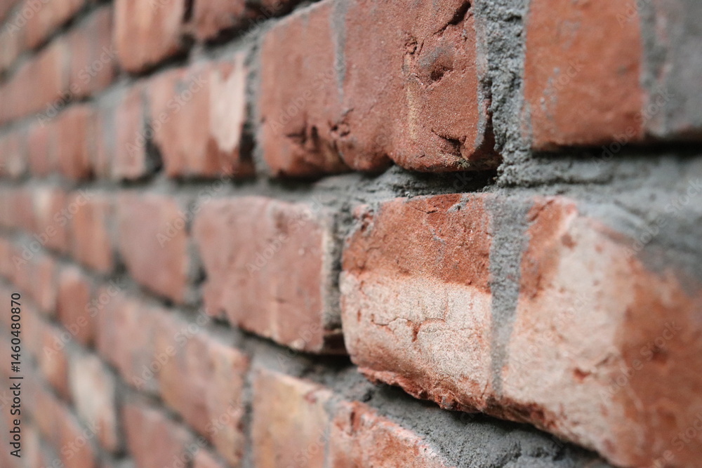 Tiled Red Brick Wall with Mortar Filling in Angled CloseUp Detail View