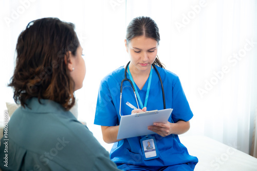 Wallpaper Mural Caregiver sitting on sofa checkup and diagnostic with woman patient about health in living room at home, caretaker sitting on couch explaining and examining woman, insurance and medical. Torontodigital.ca