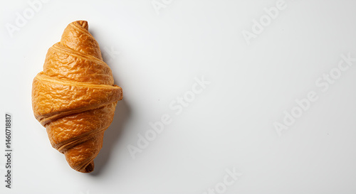 The golden croissant on pure white background with copy space 