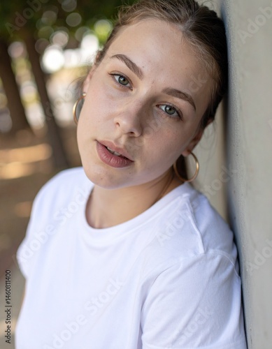 Portrait of Caucasian Woman Leaning Against Wall with Vulnerable Expression