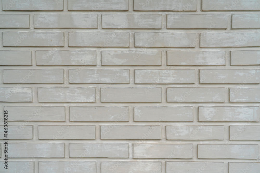 Obraz premium Close-up of a white painted brick wall with a rough texture and horizontal pattern, ideal for backgrounds or architectural design concepts