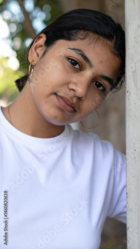 Portrait of South Asian Teen Girl Leaning Against Wall with Gentle Expression