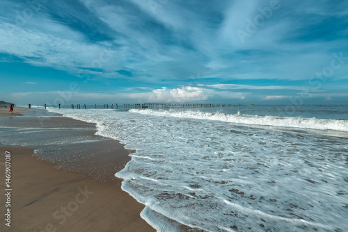 Fototapeta Naklejka Na Ścianę i Meble -  Old pier ruins extends to the sea beach view from the Venice of the East Alappuzha beach Kerala India. Famous destination of backwaters in Kerala top tourist places in Kerala.	
