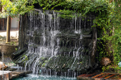 Obraz na płótnie Peaceful waterfall scene lush garden nature tranquil environment close-up view serenity concept w salonie