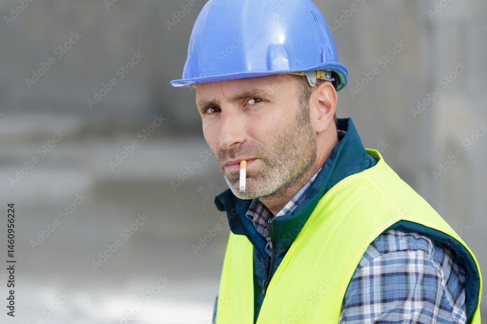 male builder smoking a cigarette male builder smoking a cigarette