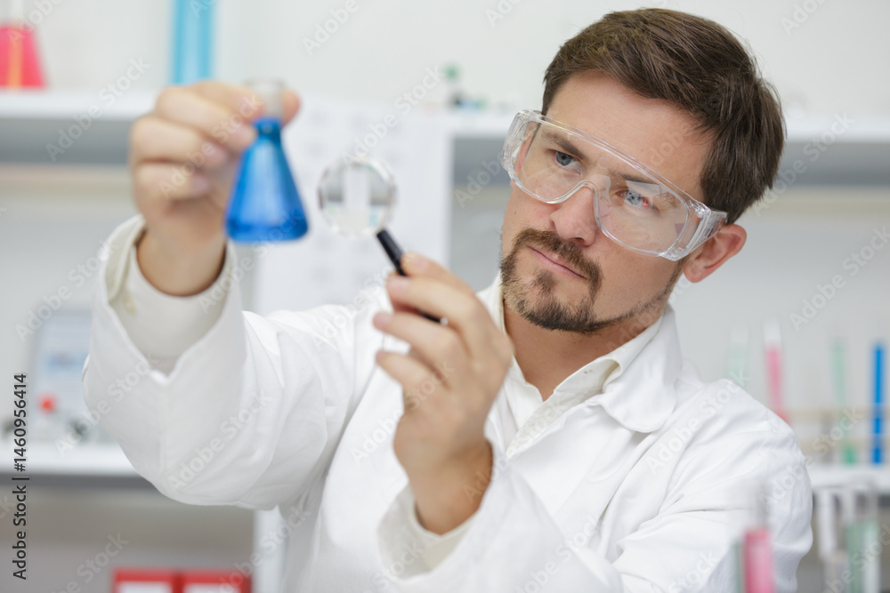 scientist standing by microscope in lab scientist standing by microscope in lab