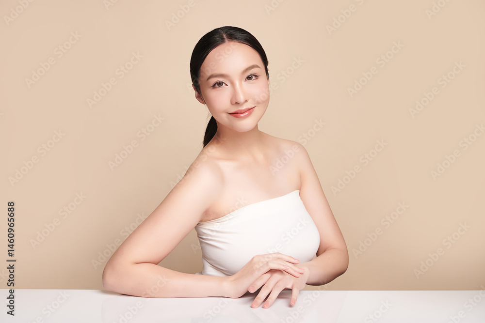 A beautiful young Asian woman with clean, fresh skin against a beige background. Skincare, facial treatment, cosmetology, beauty, and spa. An elegant portrait of an Asian woman. A beautiful young Asian woman with clean, fresh skin against a beige background. Skincare, facial treatment, cosmetology, beauty, and spa. An elegant portrait of an Asian woman.
