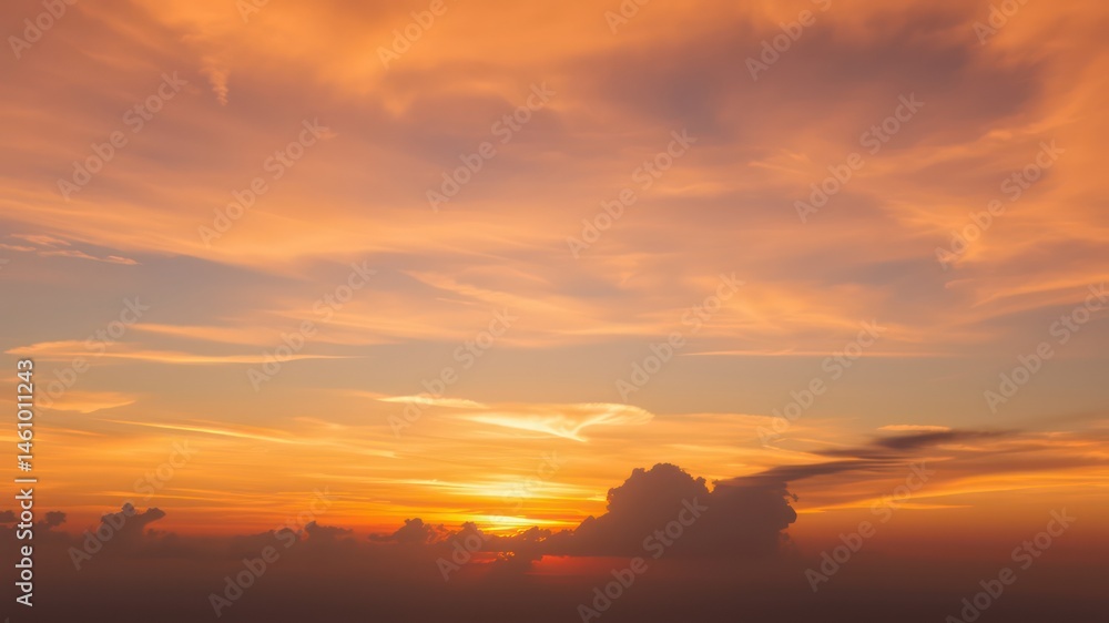Fototapeta premium Fiery sunset sky with dramatic cloudscape and warm colors