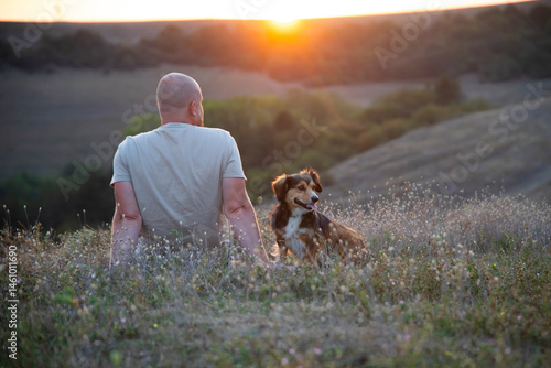 Happy dog and man playing outdoor