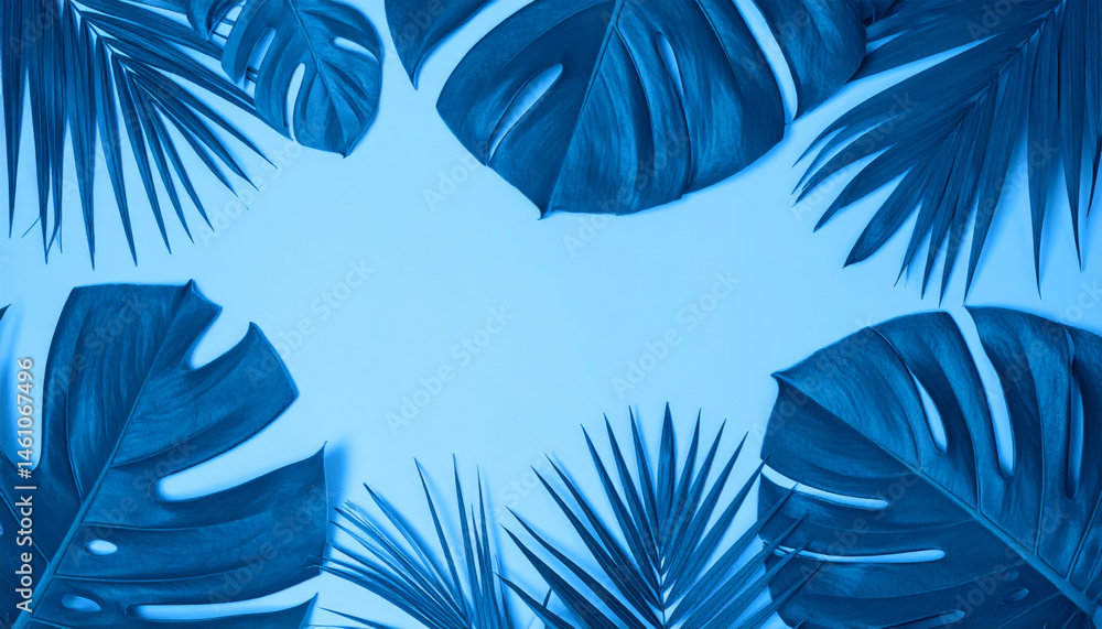 Fototapeta premium Tropical leaves in vibrant blue color create stunning foliage arrangement against soft blue background, evoking serene and calming atmosphere