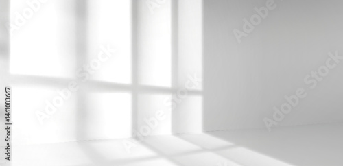 White empty room interior with window shadow silhouettes cast on blank wall from bright sunlight. Minimalistic background with black and white photo effect. Realistic abstract geometric shapes.