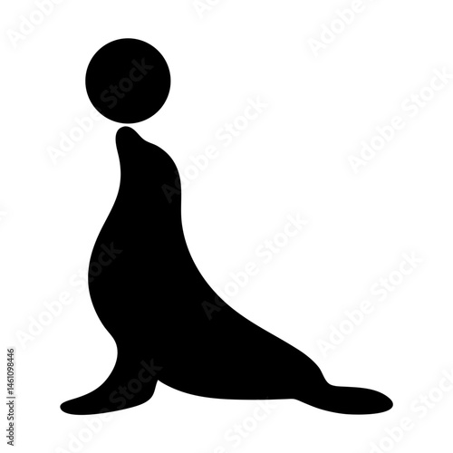 Silhouette of a sea lion balancing a ball on its nose