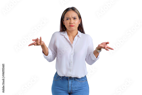 Attractive young Asian woman standing and shrugging shoulders with confused expression isolated on transparent background