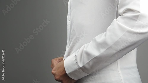 Fat man fastening or buttoning a tight white shirt. Weight loss, health care, unhealthy eating concept on a grey background.